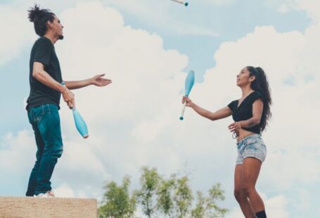 Street Performers - Man and Woman Juggling Together