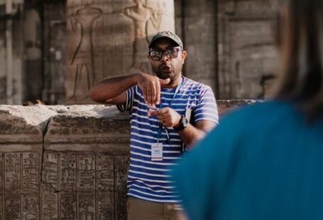 Educational Tours - A Man in Striped Shirt Serving as Tour Guide