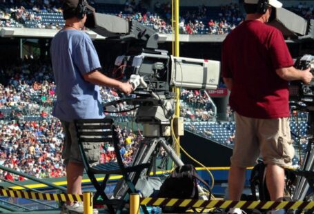 Media Platforms - 2 Camera Man Standing in a Green Metal Stage during Daytime