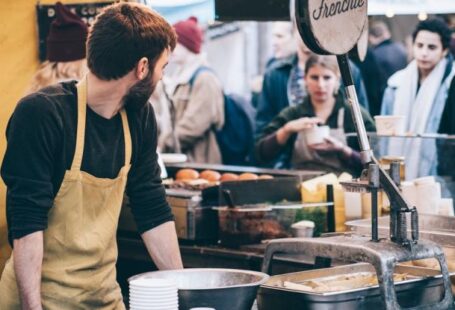 Food Market - Man Standing in Front of Bowl and Looking Towards Left