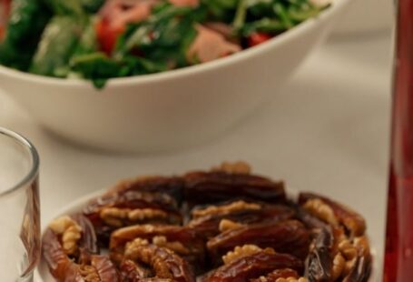 Food Culture - A table with plates of food and a glass of wine