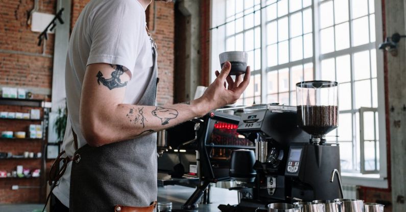 Coffee Tasting - Man in White T-shirt Pouring Coffee on Black Coffee Maker