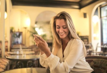 Modern Coffee Bars - Cheerful female having drink in elegant bar